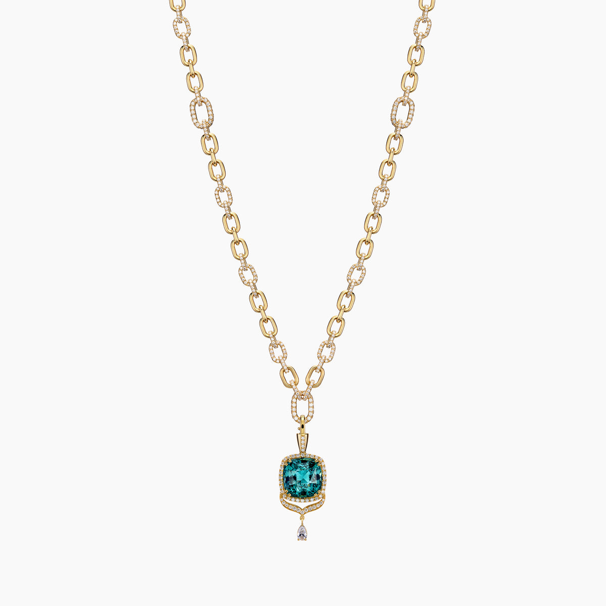 Gold pendant with a center tourmaline gemstone on a white background