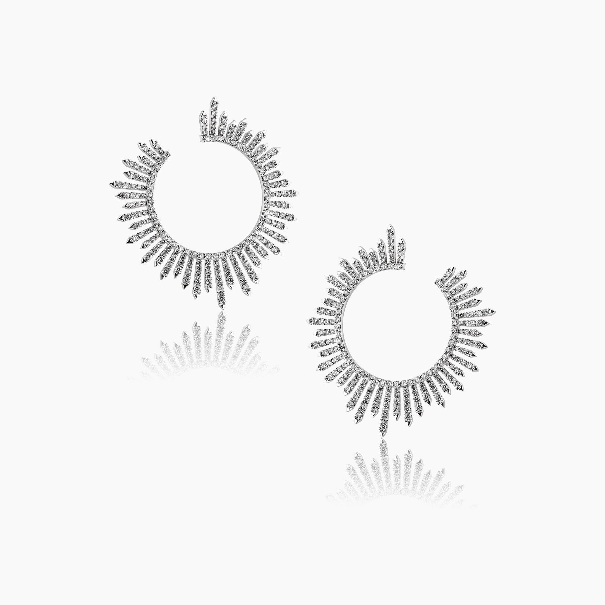 Diamond ray-like earrings, fine jewellery on an off-white background