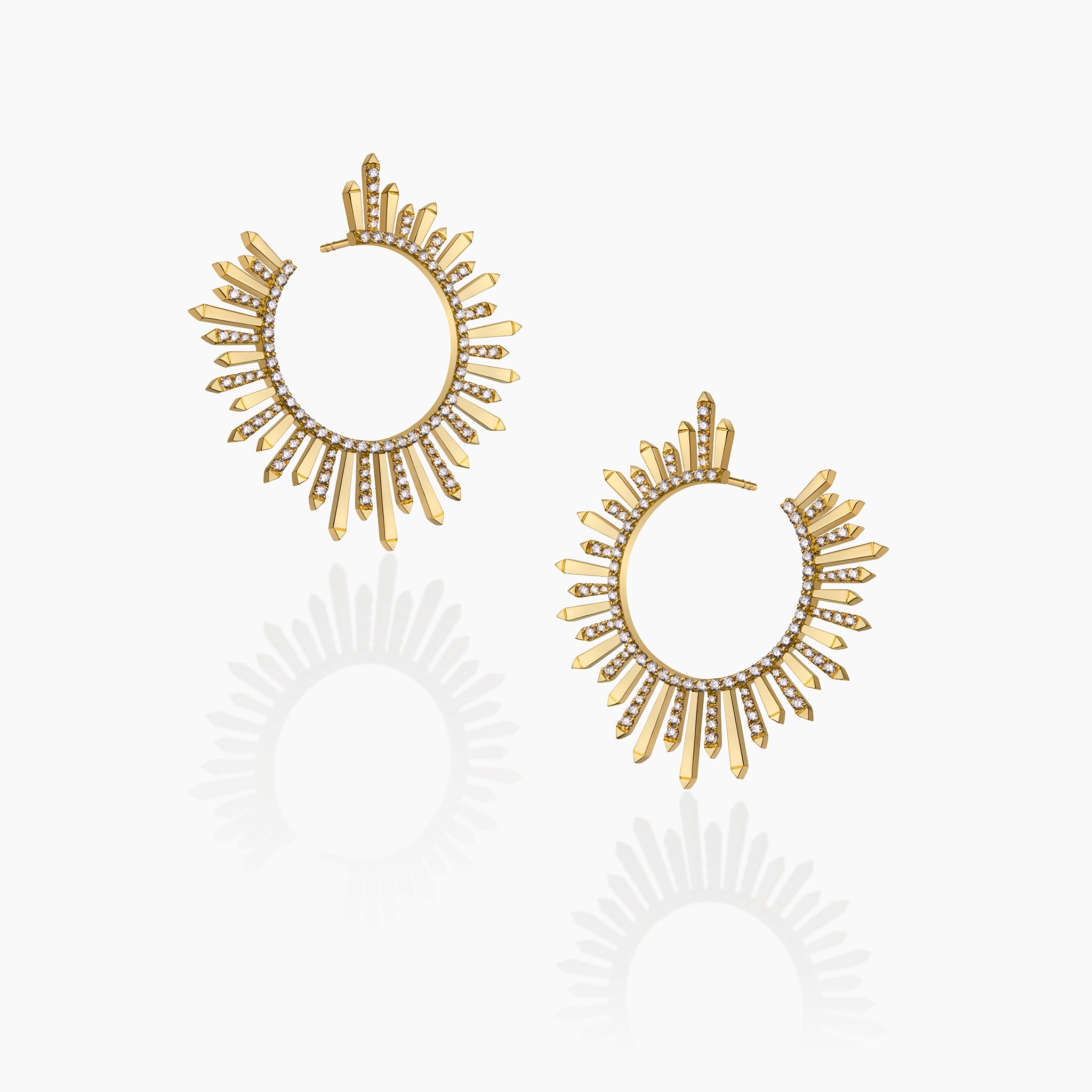 Yellow gold and diamond Polaris earrings on an off-white background