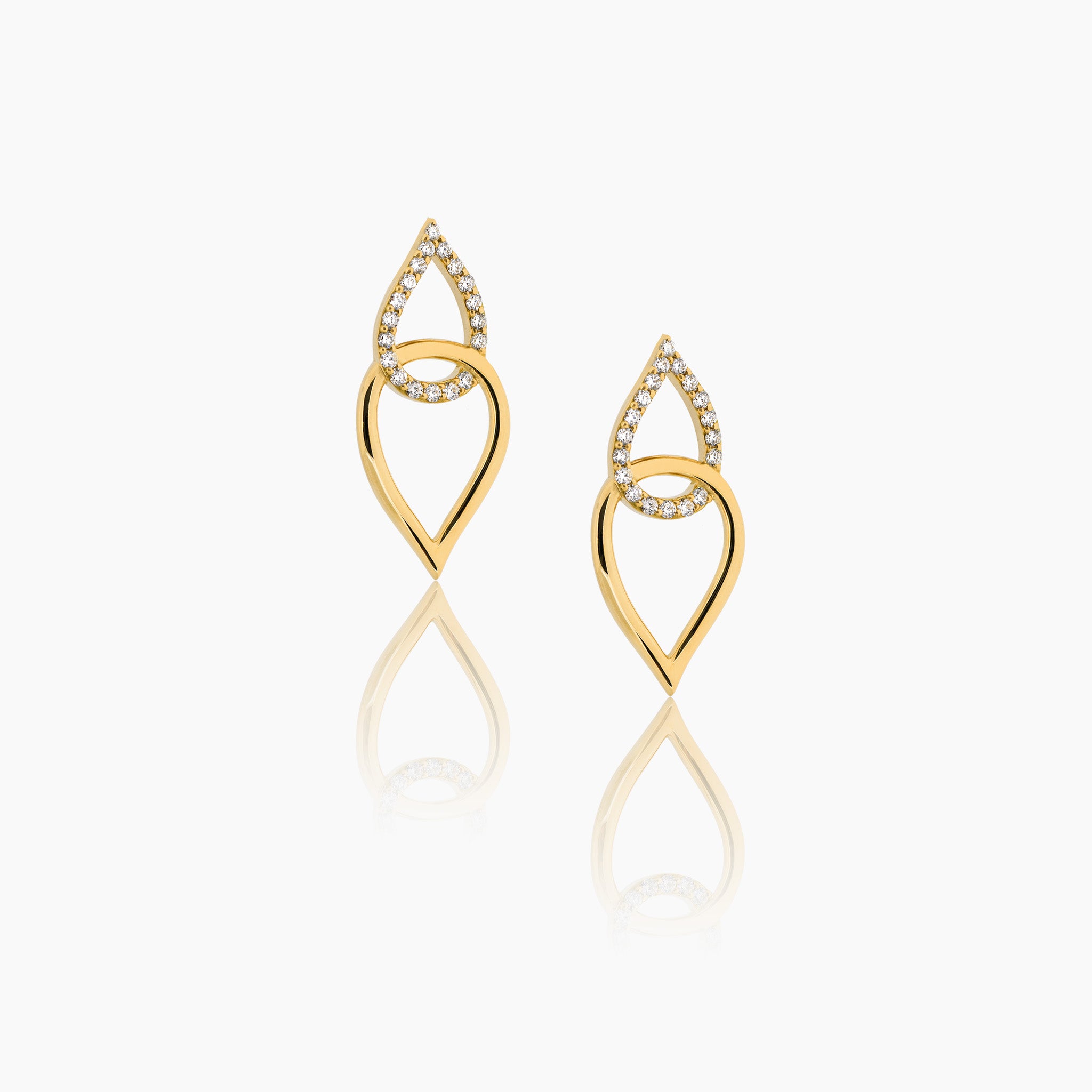 Yellow gold earrings inspired by sea knots, adorned with sparkling diamonds, showcased against an off-white background.