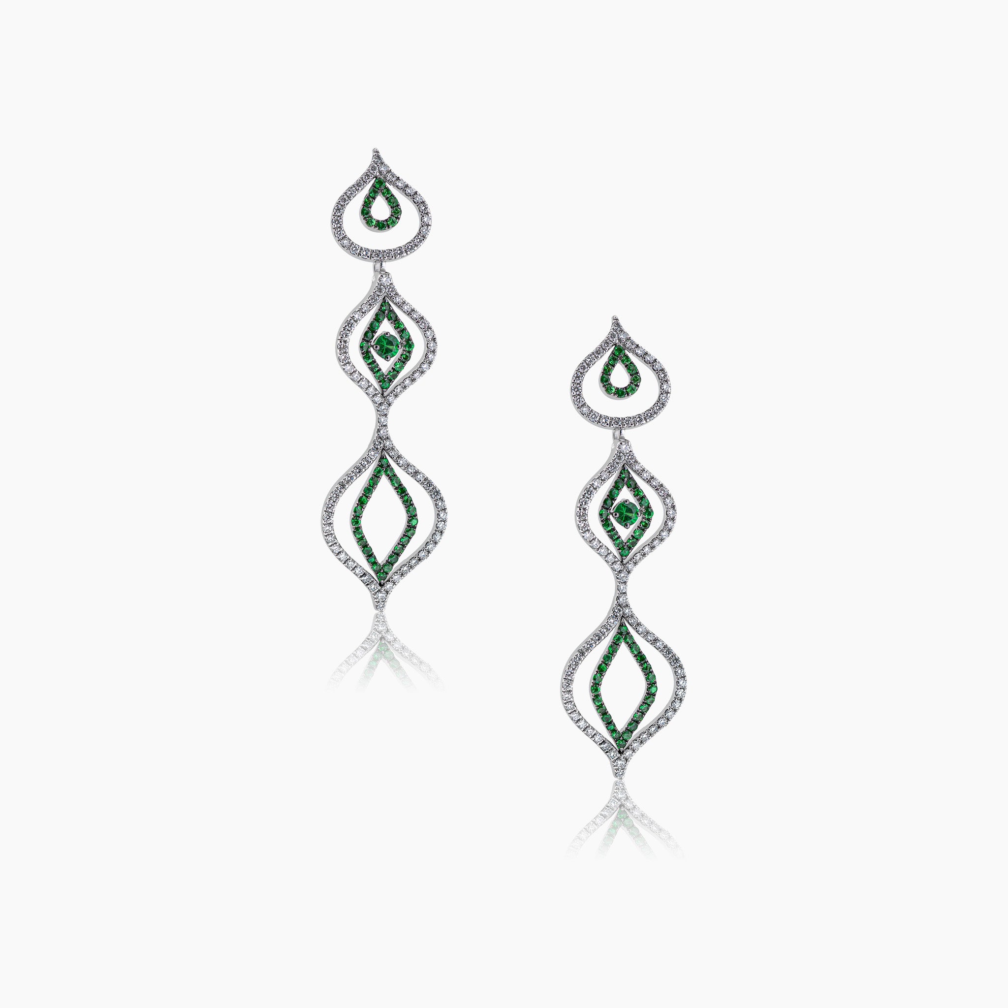 Diamond and tsavorite Venus Versatile Hanging Earrings on an off-white background.