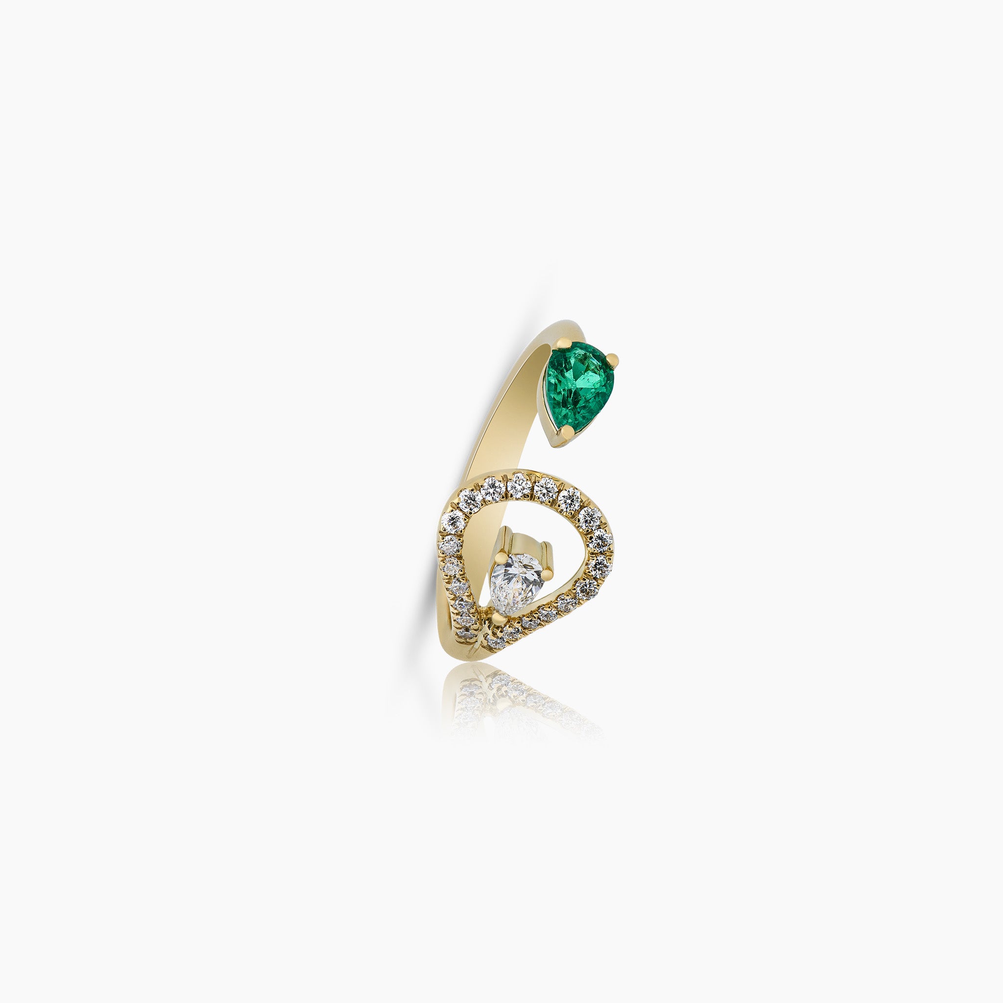 A stunning ring adorned with a vibrant emerald and dazzling diamonds, set against an off-white background.