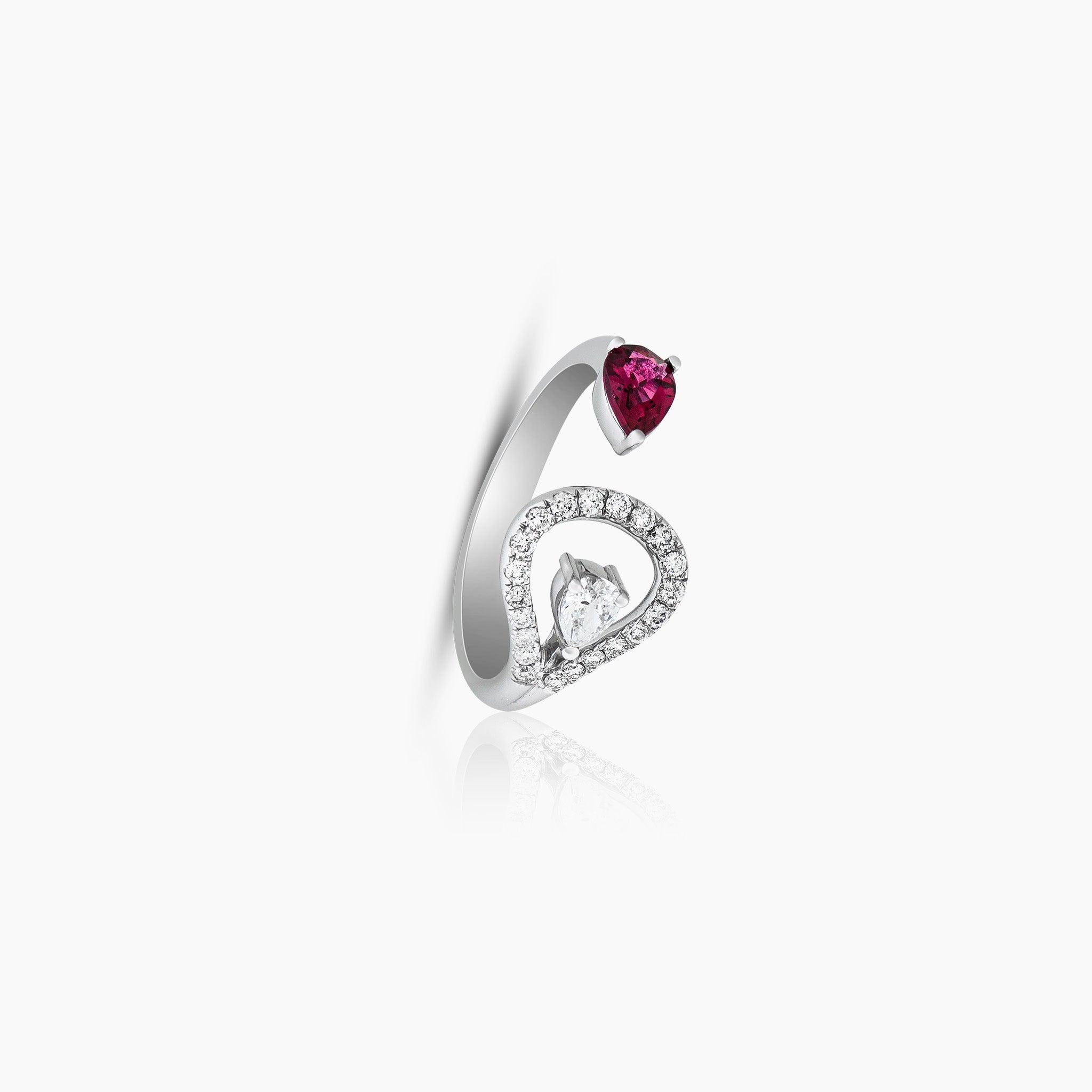 A stunning ring adorned with a pear rubellite and dazzling diamonds, set against an off-white background.