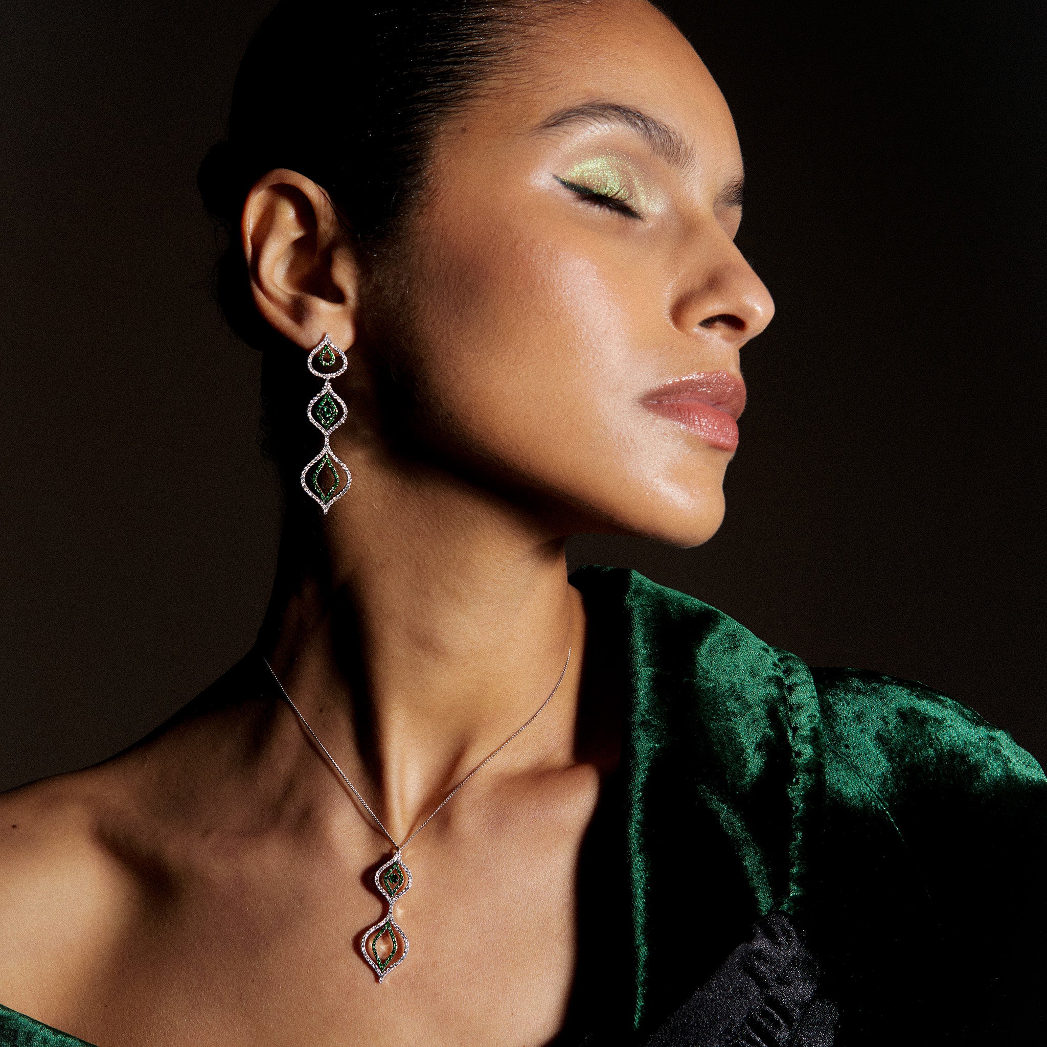 Diamond and tsavorite Venus Versatile Hanging Earrings with the attachable/detachable pendant on a model. . 
