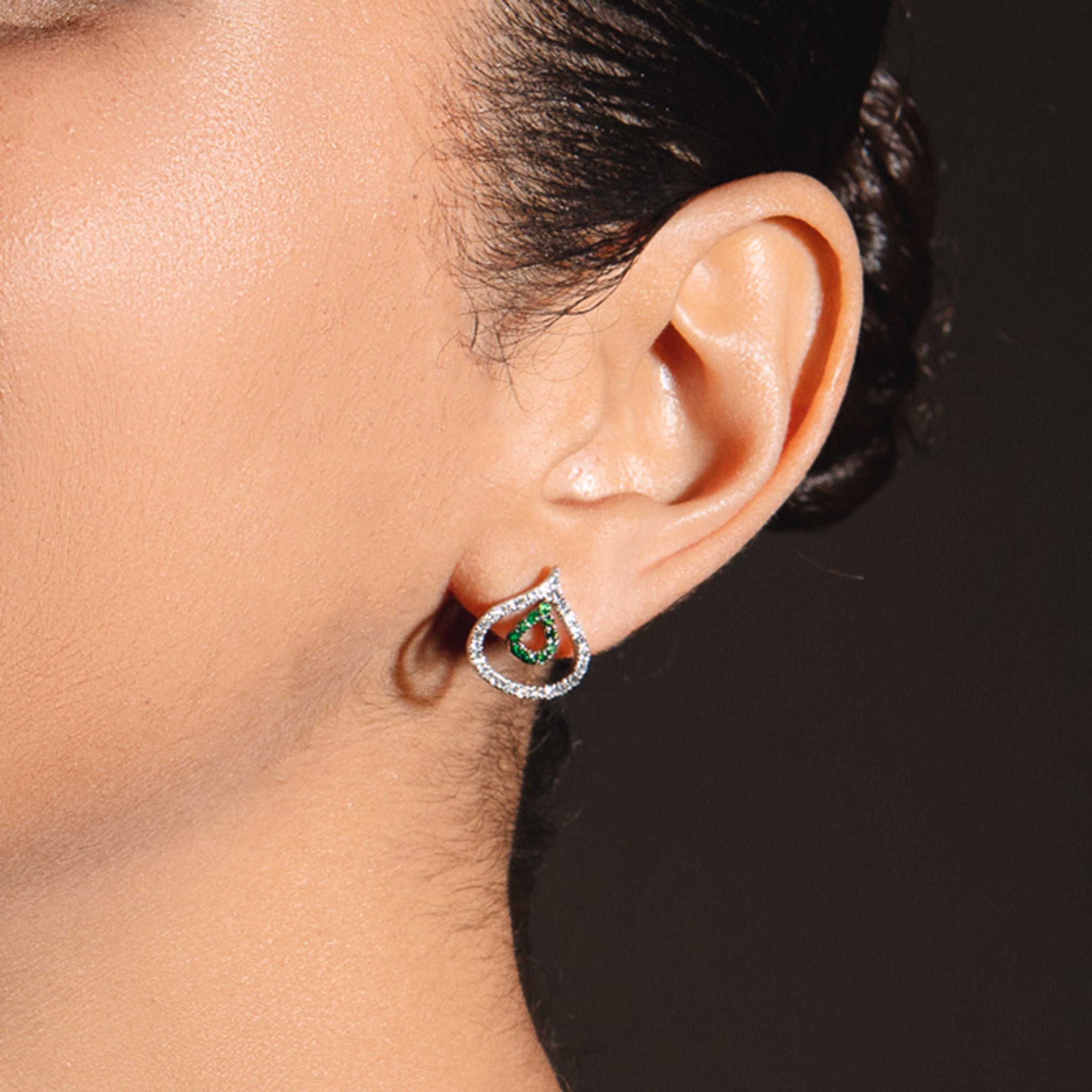 Diamond and tsavorite Venus Versatile Hanging Earrings illustrating the studs on a model. . 