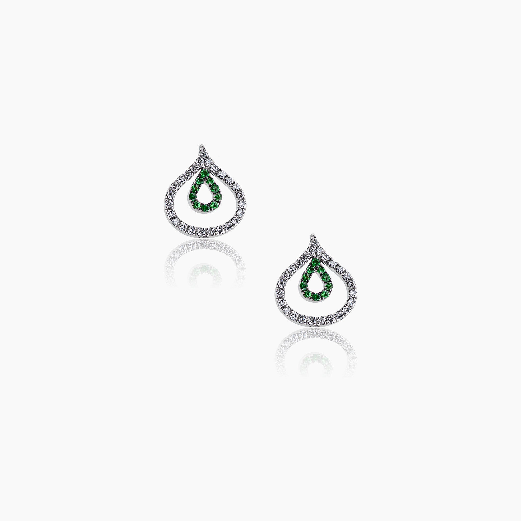 Diamond and tsavorite Venus Versatile Hanging Earrings illustrating the studs on an off-white background. 
