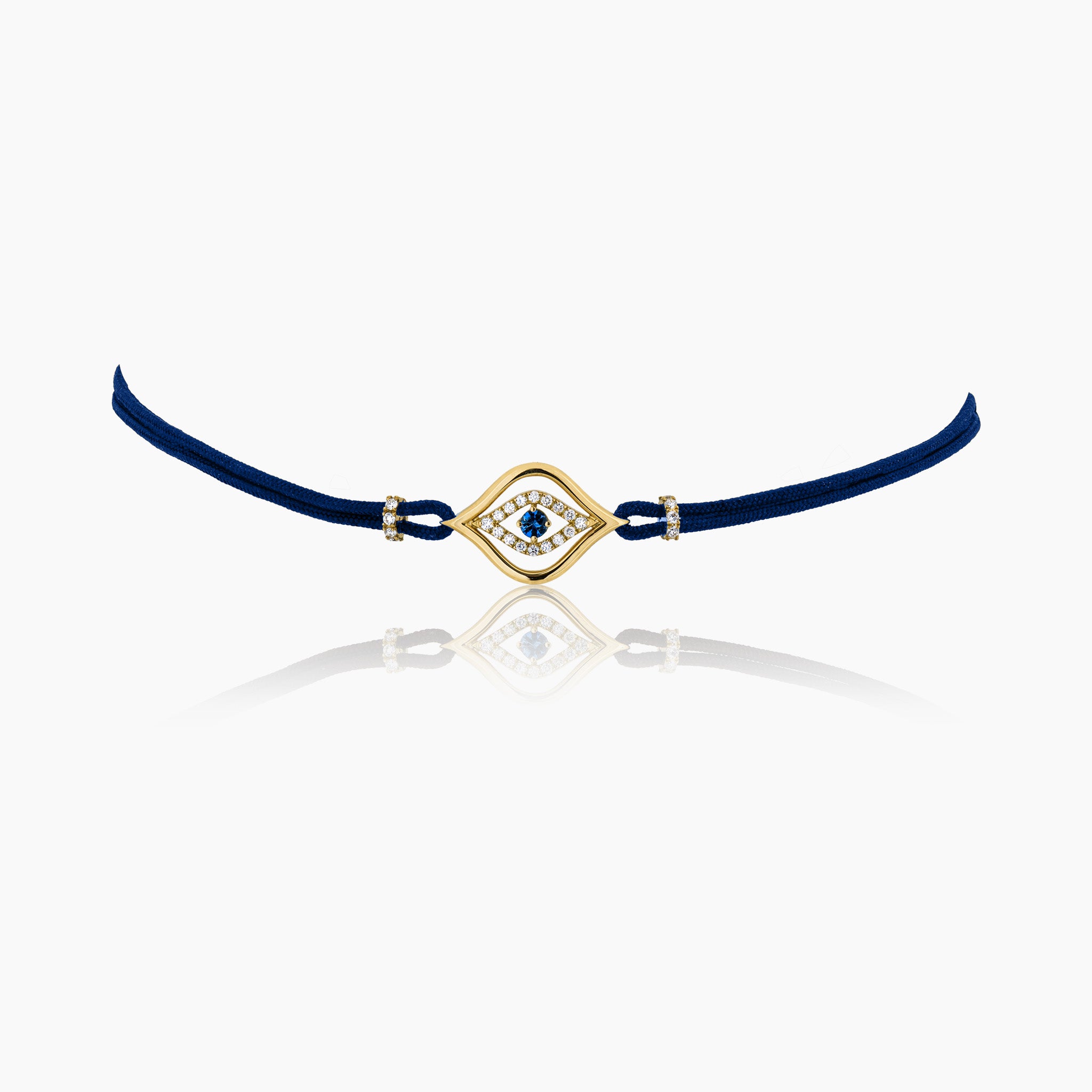 A stylish evil eye choker necklace in a navy blue cord  featuring a central sapphire surrounded by diamonds, set on a cord, presented against an off-white background.