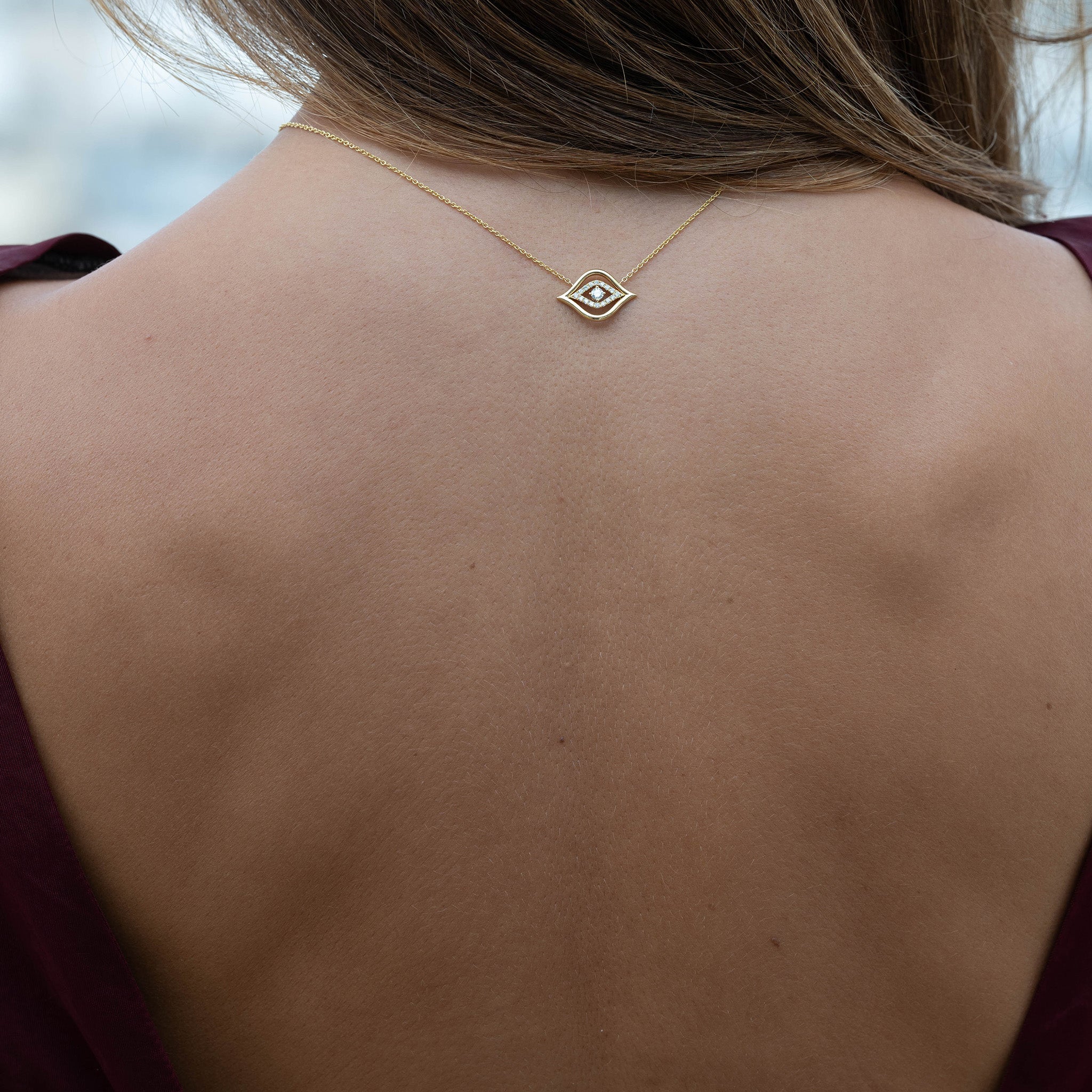 Model Wearing Evil Eye Pendant: A model gracefully adorns the Yellow Gold Evil Eye Pendant with Diamonds, radiating elegance and charm.